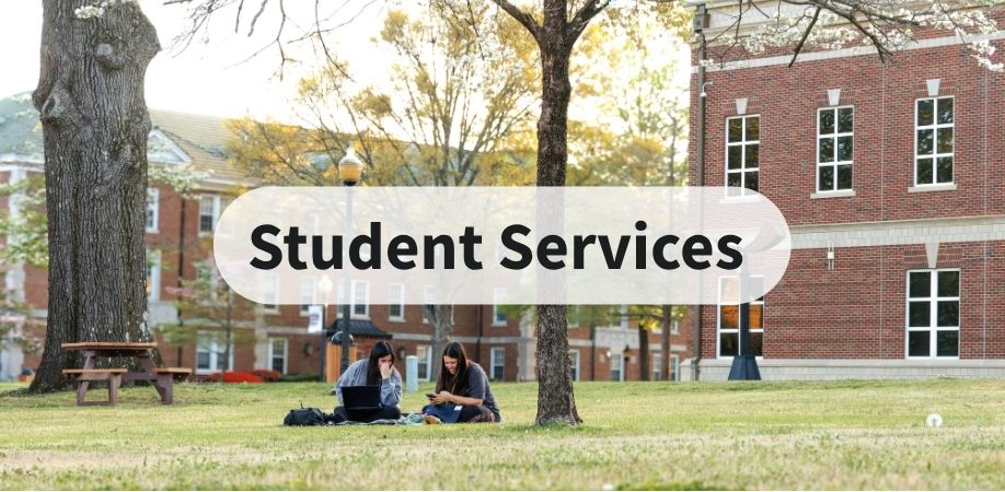 Student Services text over image of two students sitting on the lawn on campus