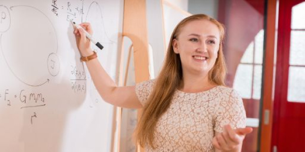 Image of Swinburne educator writing on whiteboard