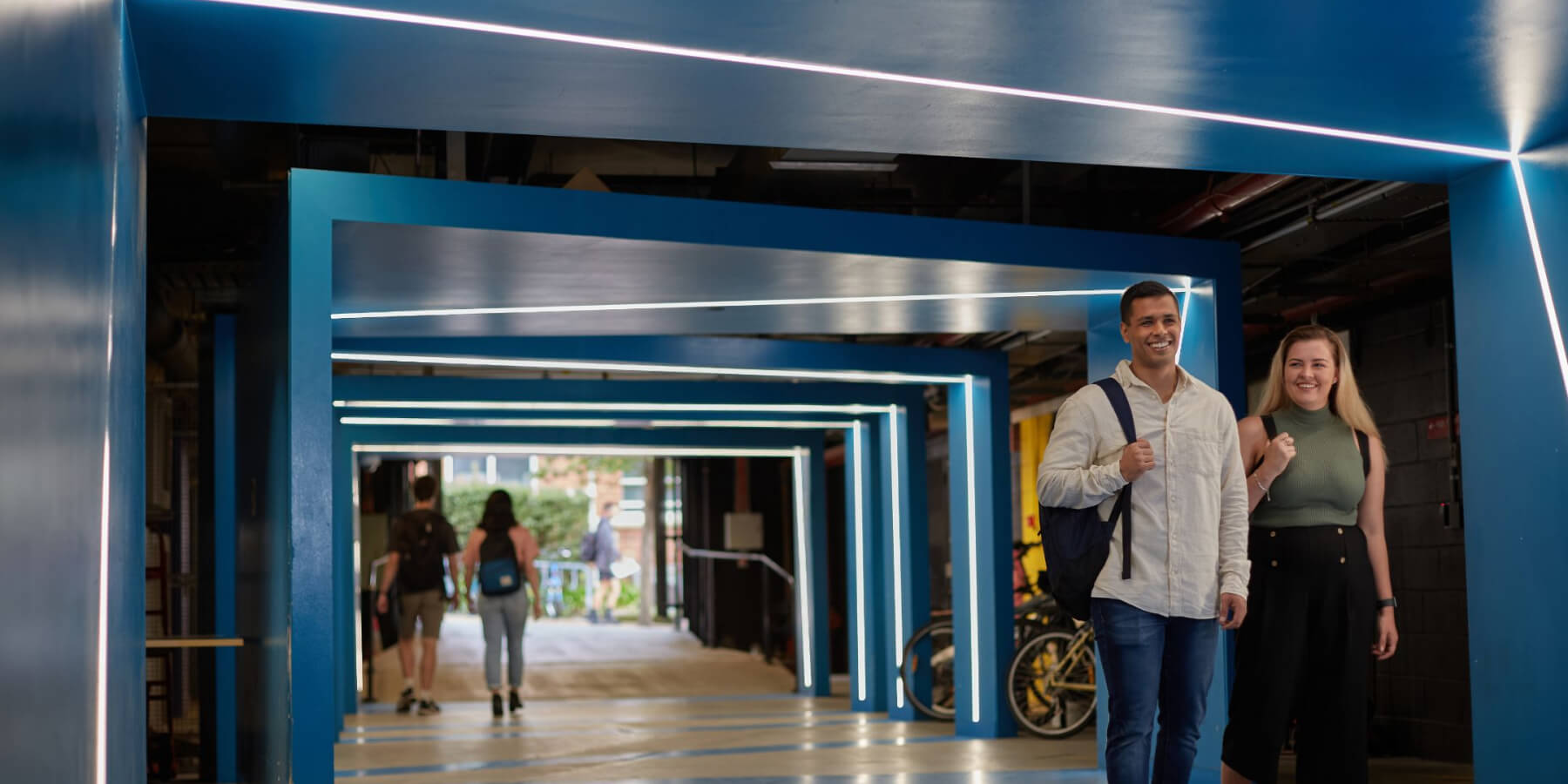 Students walking through the ground level of the Business and Arts Building
