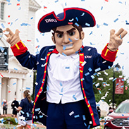 patriot man is outside enjoying graduation celebrations - confetti is falling from the sky