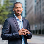dallas college graduate standing in downtown dallas